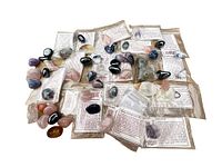 Wide view of assortment of collector rocks including tumbled rose quartz, onyx marble, amethyst, hematite rough and others, some in original packaging