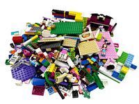 Large pile of assorted loose Lego pieces including plates, bricks, and small parts with varied colors and shapes.