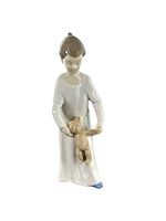 Full view of the glossy Lladro figurine showing a young girl holding a teddy bear by the hands.