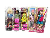 Five Barbie dolls in original sealed packaging. Dolls: three Fashionista Barbies (#91, #144, #126), Cupcake Chef Barbie, Pop Star Barbie. Minor shelf wear on some packaging.
