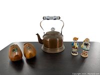 Photo showing brass and enamel tea pot, wooden shoes, and Occupied Japan figural salt and pepper shakers