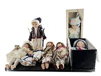 Lot of porcelain dolls including boxed and unboxed dolls with varying sizes and styles.