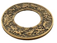 Full frontal photo of the round baroque style cherub wall mirror showing the overall design, cherub and flower reliefs, and mirror surface centrally placed.