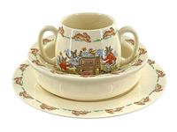 Front view of the stacked plate, bowl, and two handled cup showing bunny designs on all three pieces.