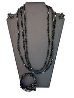 Front view of the entire jewelry set including necklace, earrings on display stand, and bracelet.