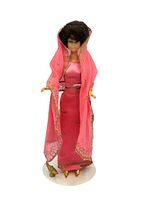 Full view of the vintage 1960s Barbie doll dressed in the pink Arabian Nights outfit with gold shoes.