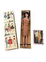 Doll, original box and trading card arranged on white background