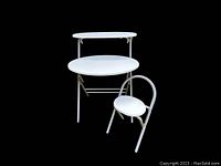 Desk and stool angled view showing white Formica surfaces and tubular metal frame
