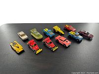 Top down view of all 10 Hot Wheels diecast cars and trucks, showing details and variety.