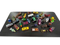 Top-down view of a variety of Hot Wheels cars featuring different models such as fantasy cars, sports cars, and more with various colors and paint styles visible.