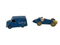 Photo showing two blue diecast models side by side, including Dinky Toys Oxo Van and Ferrari Racing Car.