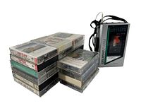 11 assorted cassette tapes stacked and Sony Walkman WM-F12 beside the stack with visible cassette window and front radio frequency display.