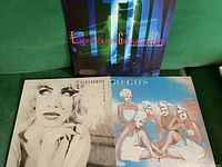 Three vinyl LP records: Elton John Greatest Hits, Eurythmics, and Go-Go's, arrangement showing album cover art and titles