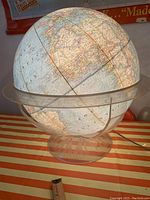 Full lit globe on tabletop showing overall condition and appearance