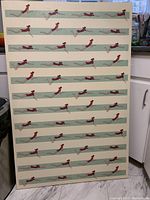 Full view of large canvas print showing repeated swimmer graphic in horizontal rows.