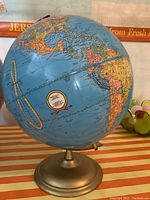Front view of the globe showing Pacific Ocean, parts of North and South America with detailed country markings.