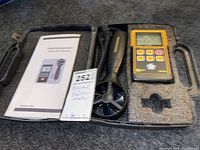 Digital anemometer device, sensor probe, case, and manual shown fully assembled in black foam molded carrying case