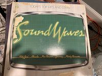 Album cover 'Sound Waves' compilation featuring Billy Joel, Blondie, Pat Benatar, Journey, Rocky Burnette with some corner damage and wear