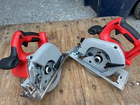 Two saws positioned on wooden surface side by side