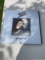 Front cover of the Giants of Jazz LP album featuring Billie Holiday on a white background with framed photo and logo.