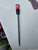 Full view of Milwaukee 7/16" QUIK-LOK Extension, showing length and overall shape on table.