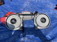 Top-down view showing dual wheel blade assembly inside open frame on blue tarp.