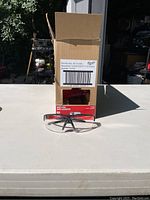 Box labeled Milwaukee Clear Safety Glasses with one pair displayed in front showing black nose bridge and clear lenses.