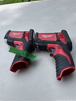 Two Milwaukee 12V units, sensor gun and battery handle, showing branding and condition