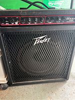 Front view of the Peavey Basic 112 bass amplifier showing control panel, knobs, input jack, and speaker with mesh grill.
