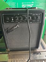 Front view of the Traynor Guitar Mate 15 amplifier showing control panel and grille with logo.