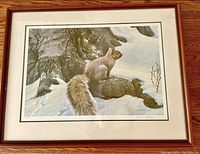 Framed print showing a squirrel in snow against a tree trunk, signed by Robert Bateman.