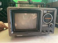 Front and angled front view of Sterivision portable black and white television unit with CRT screen and control knobs