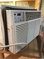 Front view of the GE window air conditioner showing control panel, vents and power cord.