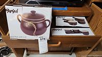 Photo showing boxed Parini chili pot with lid and boxes for 3 bowl condiment set and 4 chili bowl set.