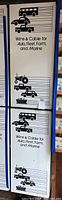 Photo showing full view of two tall white metal cabinets with graphics of vehicles and text 'Wire & Cable for Auto, Fleet, Farm, and Marine'
