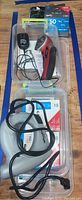 Full view of Power Shot 8150 stapler, Skil 207 rotary cutter, manual stapler, and staple packs in transparent container on wooden table