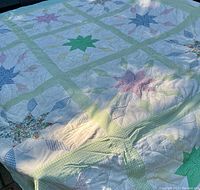 Full view of quilt showing star patterns, grid design, and overall size.