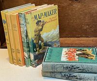 Seven vintage adventure books including two by G.A Henty and one with colorful dust jacket titled The Map-Maker.