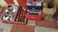 Bins containing various Christmas ornaments, mostly Hallmark brand, some vintage, in plastic storage containers