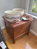 Antique walnut commode box with two porcelain bowls and doilie placed on top, showing the item assembled and overall condition.