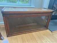 Front view of the dark stained wooden barrister bookshelf with glass door showing scratches and surface wear.