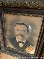 Ornate framed print portrait of Bat Masterson with attached postcard showing detail of face and frame.