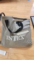Gray fabric carry bag with black handles and white Intex logo, labeled 'single mattress'.