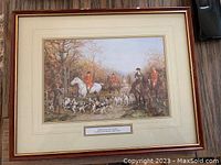 Framed hunting scene print by Heywood Hardy showing a traditional fox hunt with riders and hounds in a natural setting, with title plaque visible.