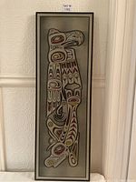 Full front view of the framed etched aluminum Thunderbird plaque showing the traditional Indigenous art design in red, gold, black, and white.