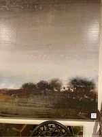 Close-up photo showing textured brushwork and illegible signature in lower right corner.