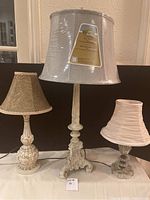 Set of three lamps on table showing overall condition and setup.