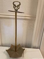 Full view of the brass umbrella stand showing umbrella-shaped base and central pole