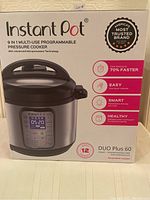 Front view of Instant Pot DUO Plus 60 box showing product image and key features such as 9-in-1 functionality, 6 quart capacity, and fast cooking claims.