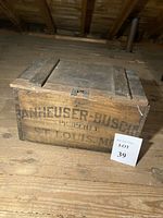 Side view showing Anheuser-Busch logo and branding, with intact lid closed.